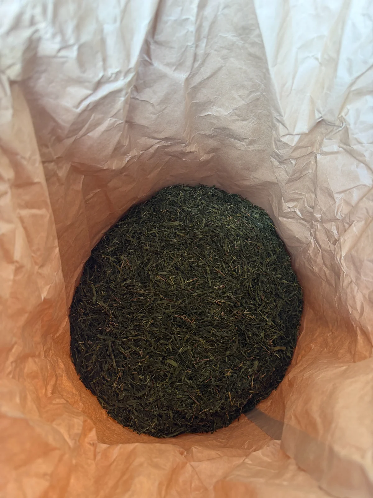 Finished Japanese green tea inside a paper-lined bag
